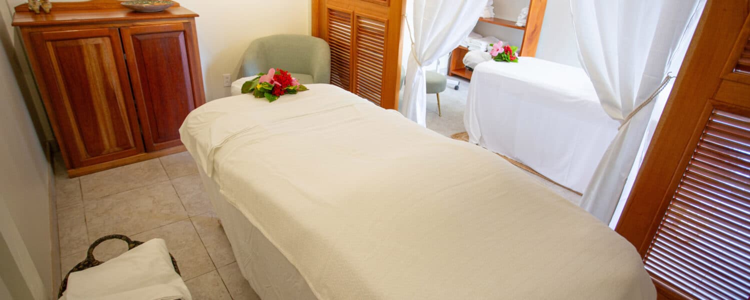 Relaxing spa treatment room with soothing decor and comfortable massage beds.