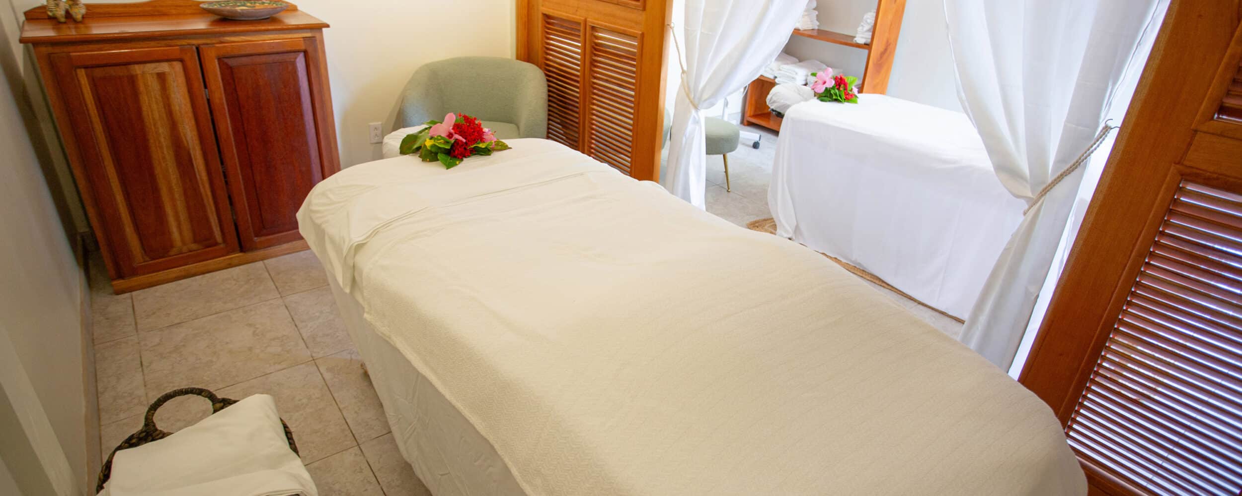 Relaxing spa treatment room with soothing decor and comfortable massage beds.