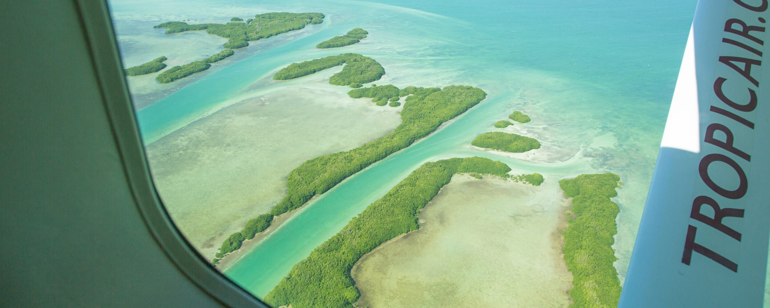 Breathtaking aerial view of serene tropical islands and clear turquoise waters.