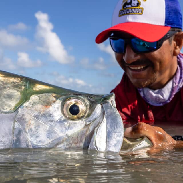 http://Angler%20joyfully%20holds%20a%20fish,%20celebrating%20a%20successful%20catch%20in%20nature.