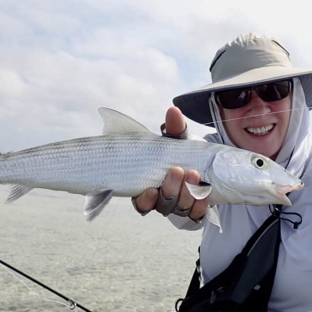 http://Happy%20angler%20proudly%20holds%20a%20silver%20fish%20during%20a%20perfect%20fishing%20adventure.