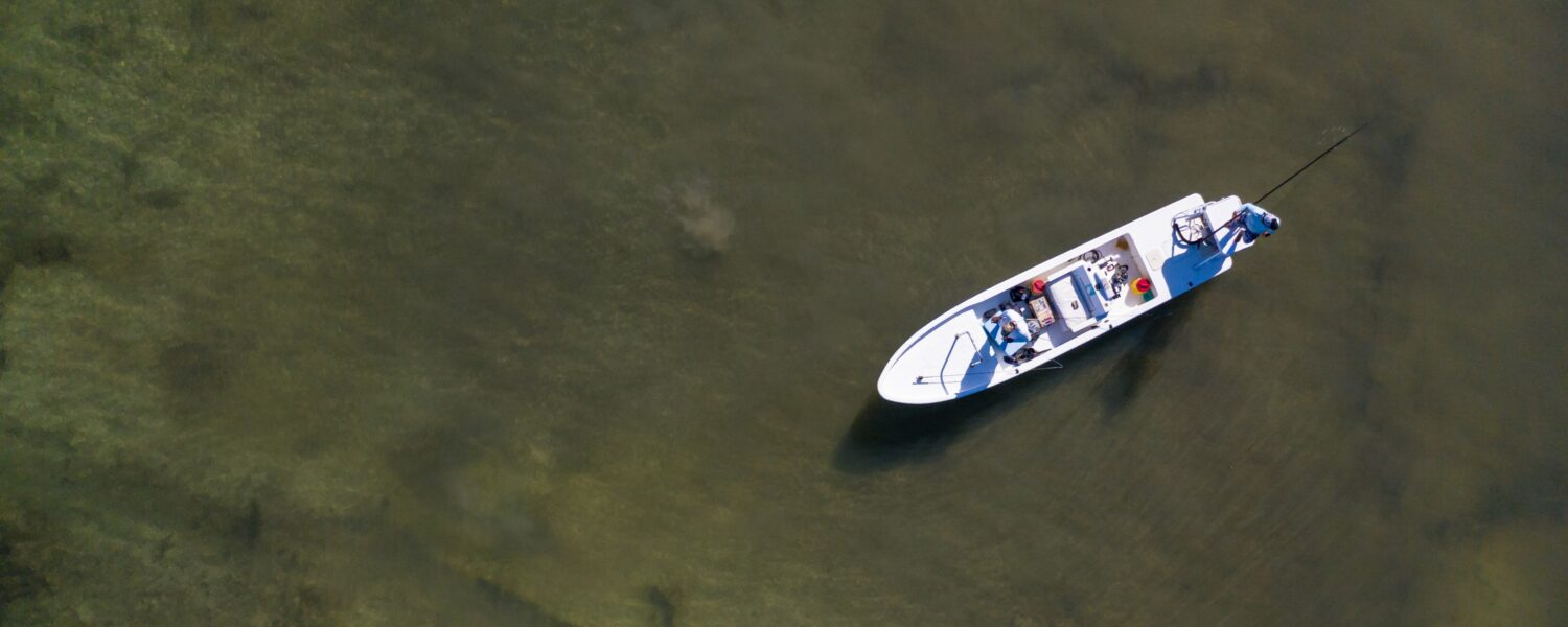 Fishing on serene waters in a small boat, enjoying a peaceful adventure.