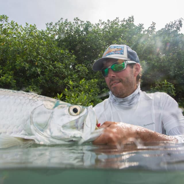 http://Man%20fishing%20in%20mangroves,%20capturing%20the%20thrill%20of%20a%20fishing%20adventure.