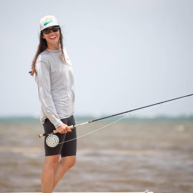 http://Happy%20angler%20enjoying%20a%20beautiful%20day%20fishing%20by%20the%20shoreline.