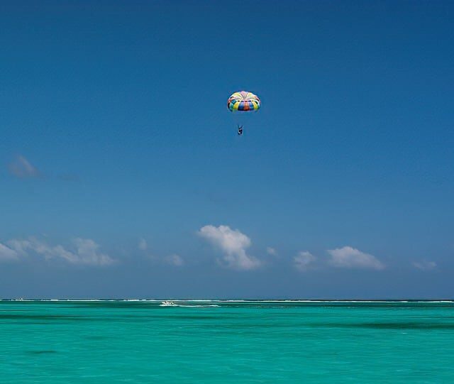 Enjoy breathtaking parasailing above stunning turquoise waters and clear blue skies.