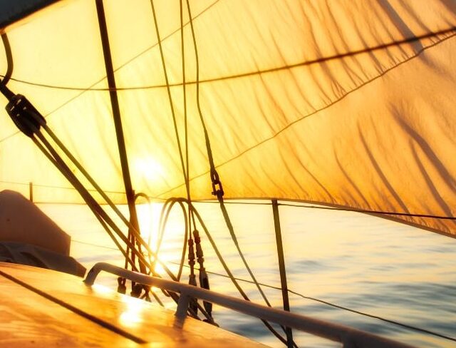 Sailing through a serene sunset over calm waters.