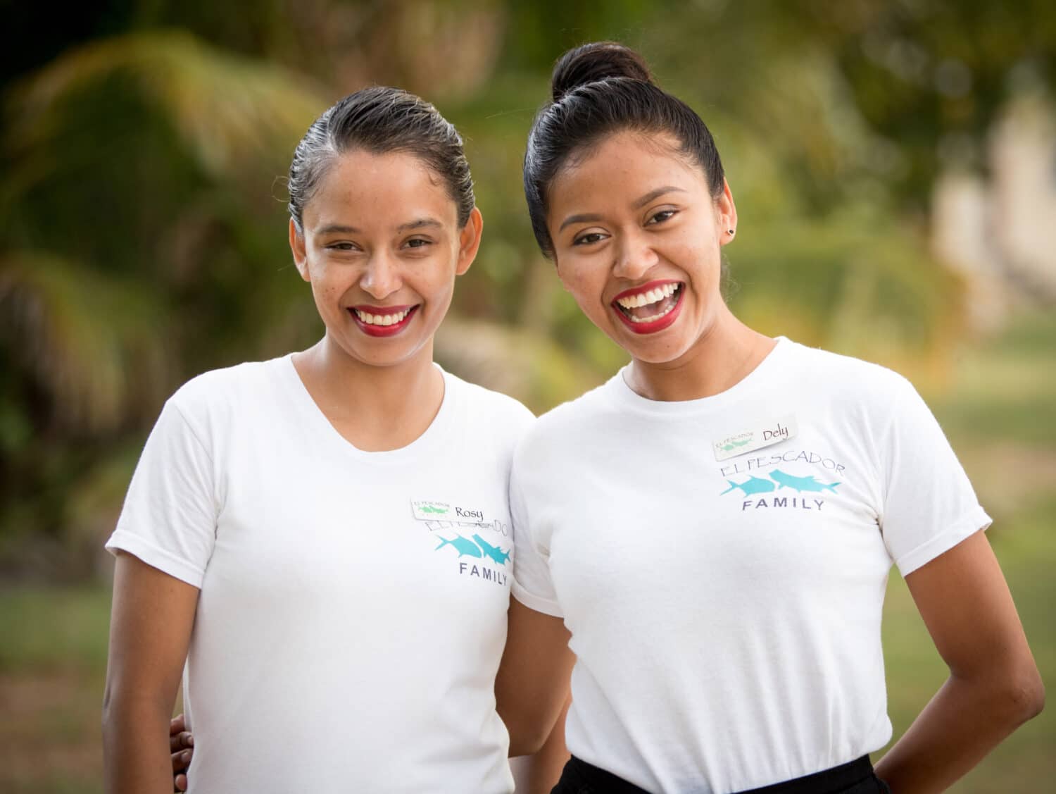 Friends sharing smiles in a beautiful tropical setting.