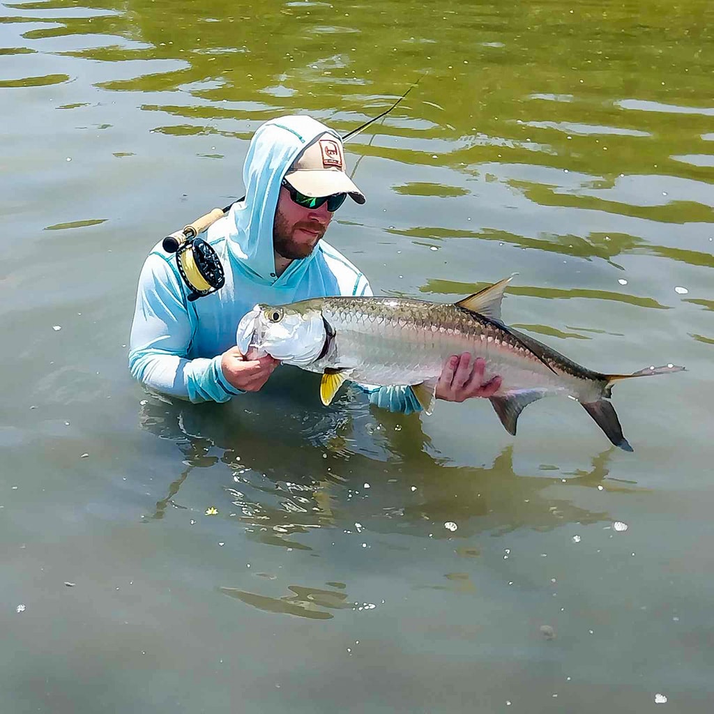 Angler proudly displays a large fish during an exciting fishing trip.