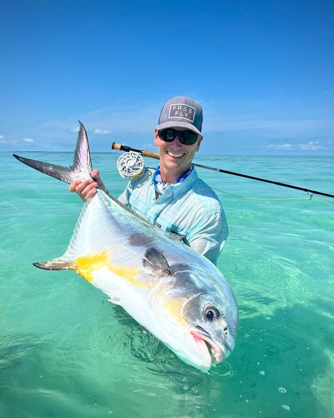 Exciting ocean fishing adventure with a big catch under a clear blue sky.