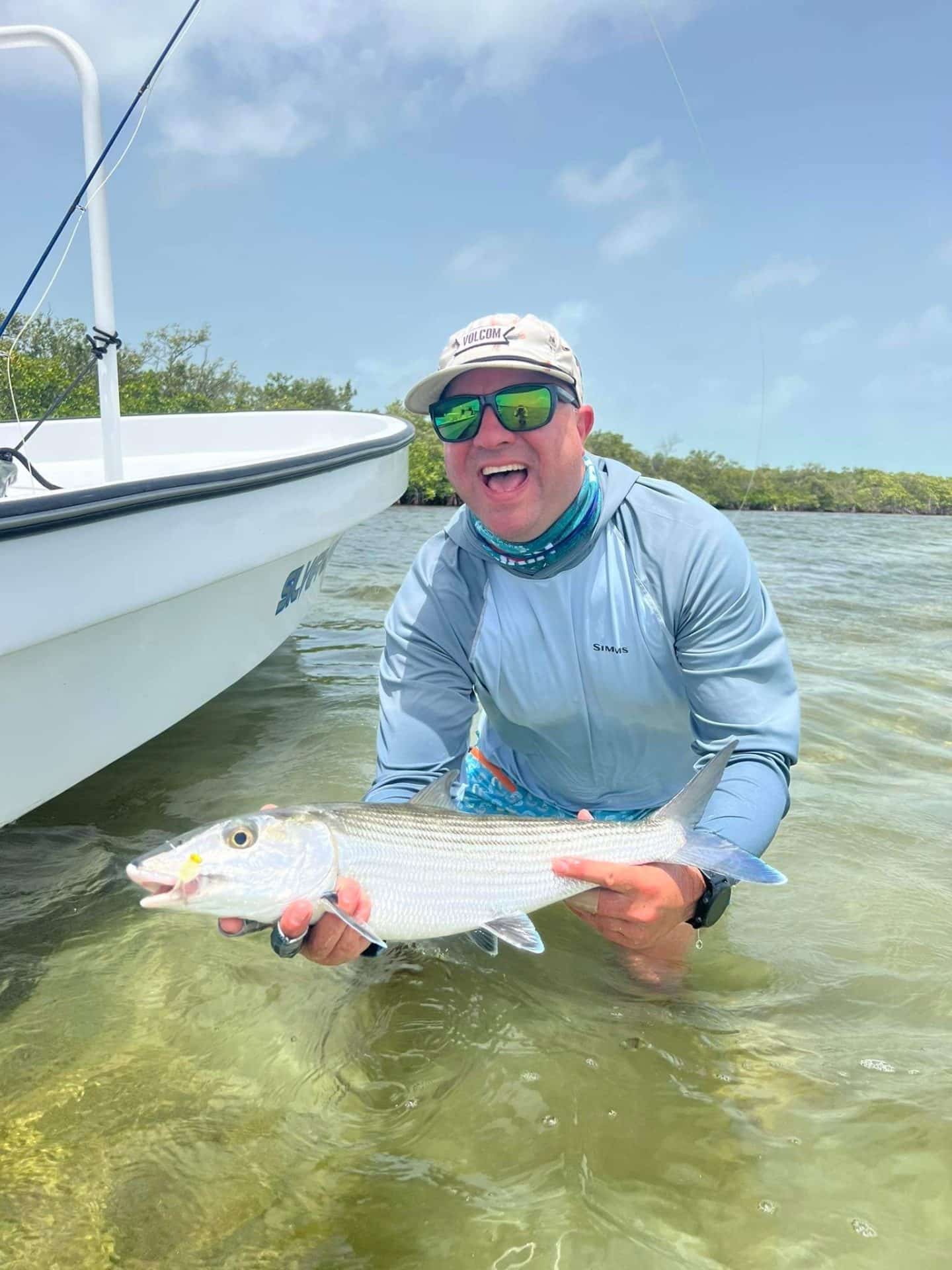 Angler showcasing a successful catch on a sunny fishing adventure.