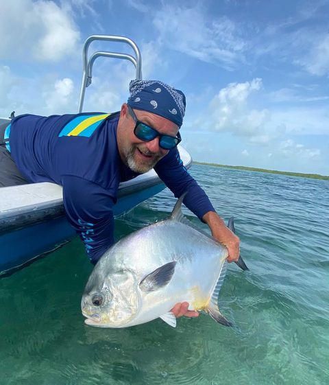Catching a stunning permit fish on a sunny ocean adventure.