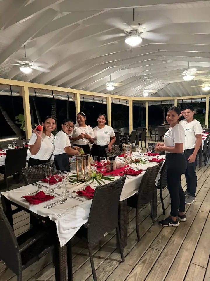 Dedicated staff preparing an elegant dining setup in a beautiful venue.