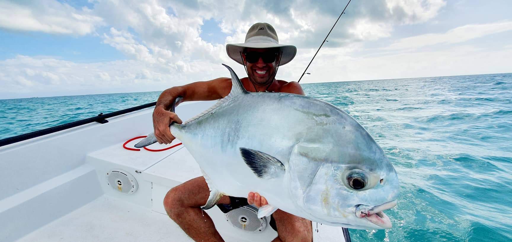 Exciting open water fishing trip, showcasing a proud angler with a stunning catch.