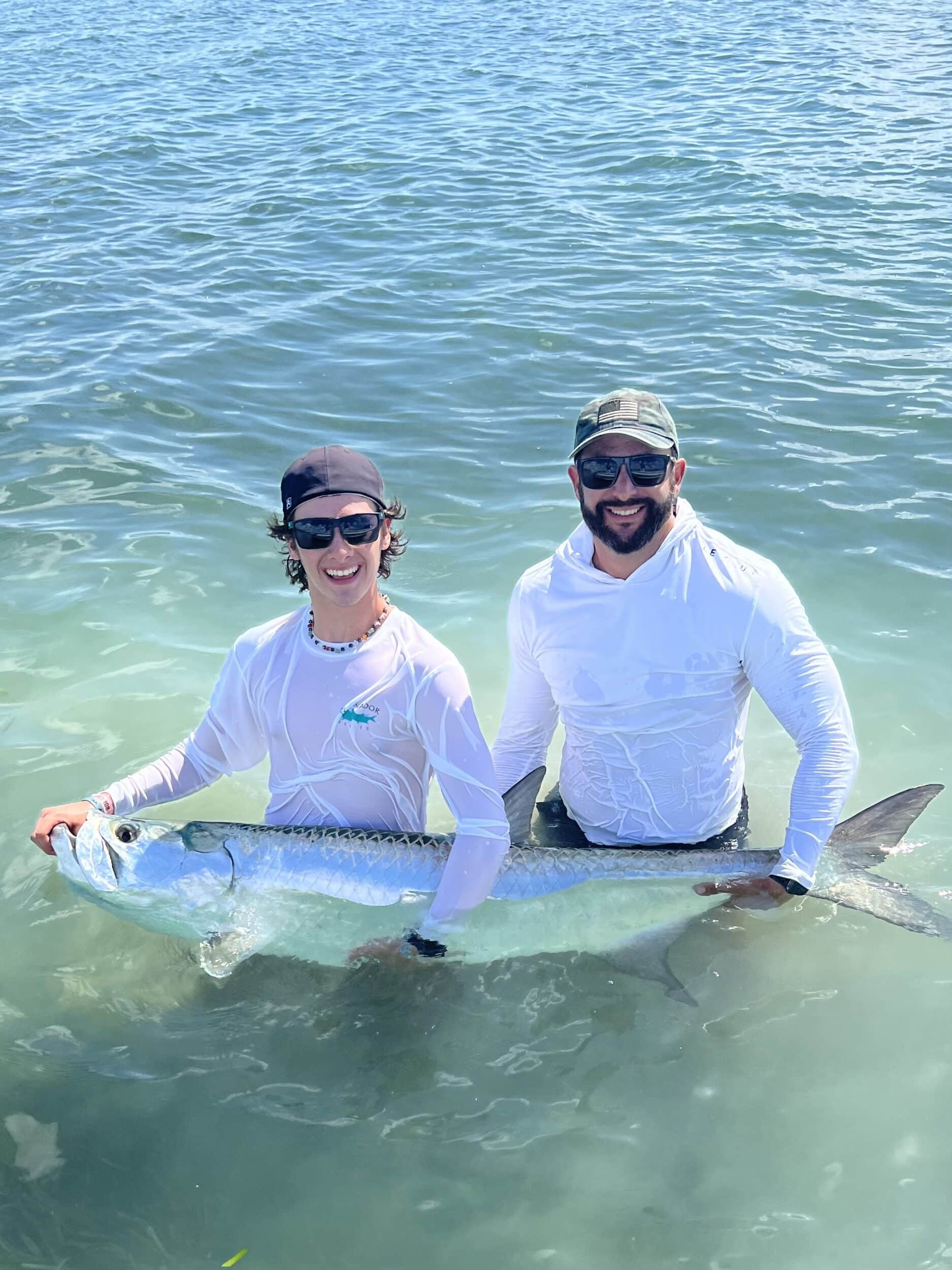 Two anglers proudly display their impressive catch during an exciting fishing trip.