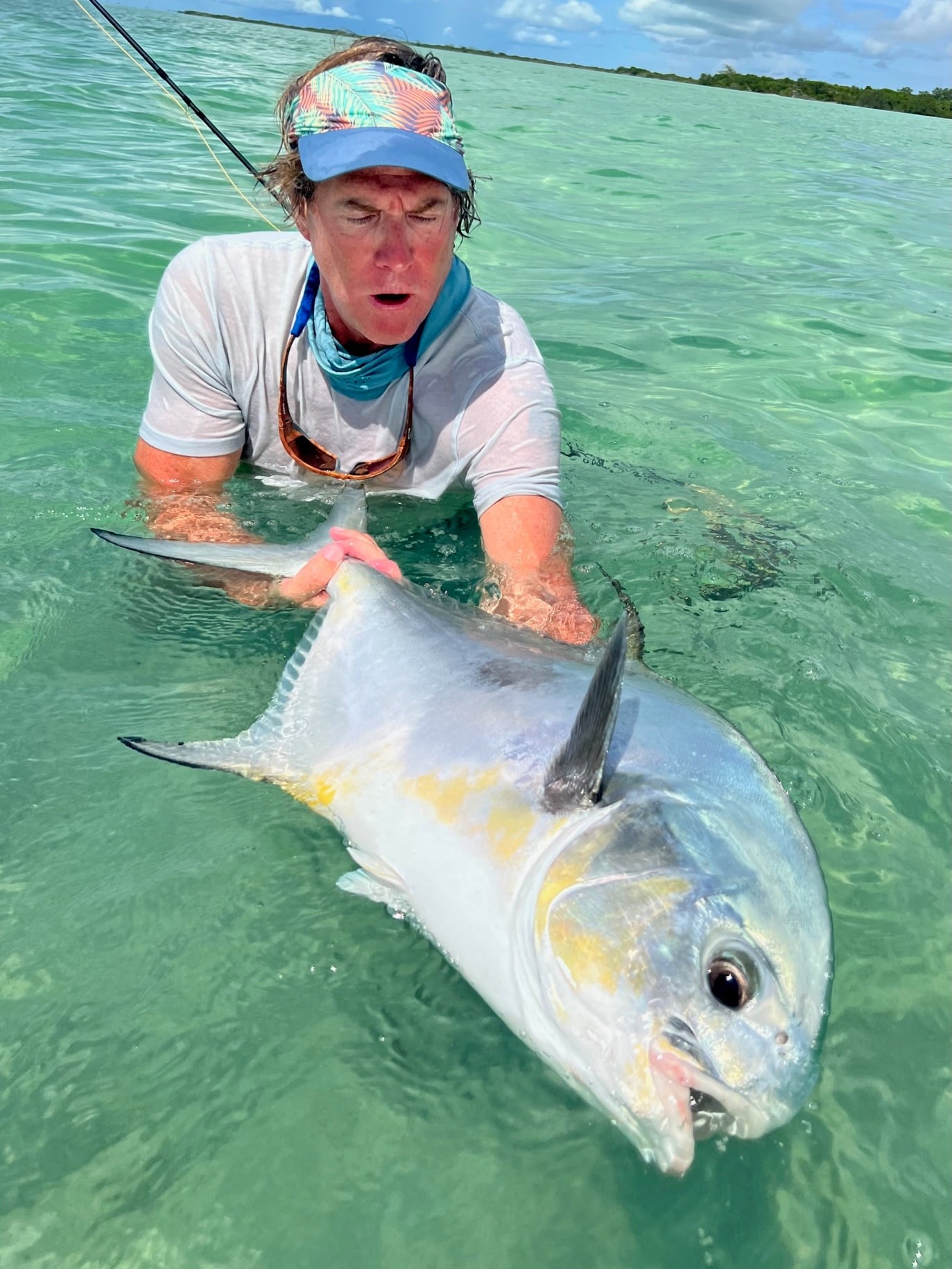 Fishing thrill in crystal-clear waters, showcasing an impressive catch.