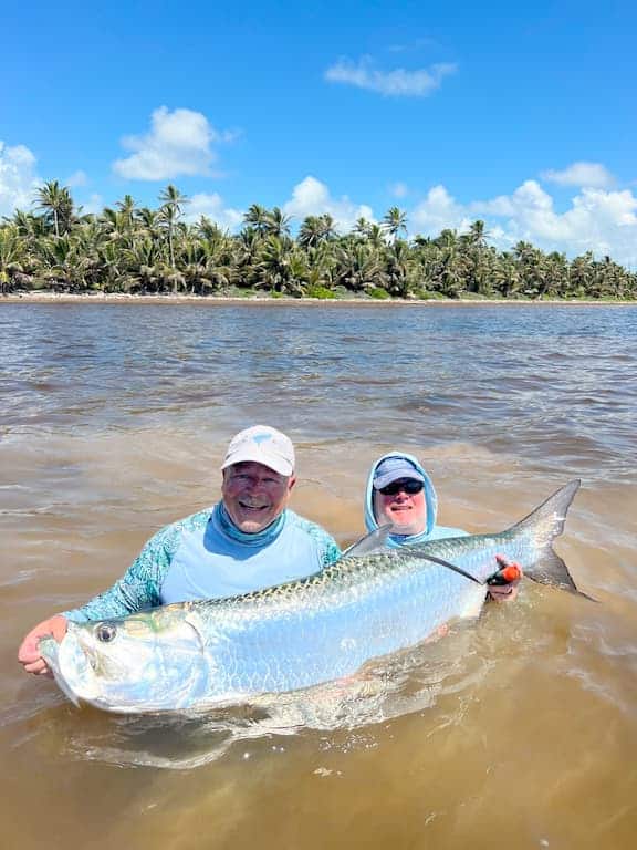 Thrilling tarpon catch during a tropical fishing adventure.