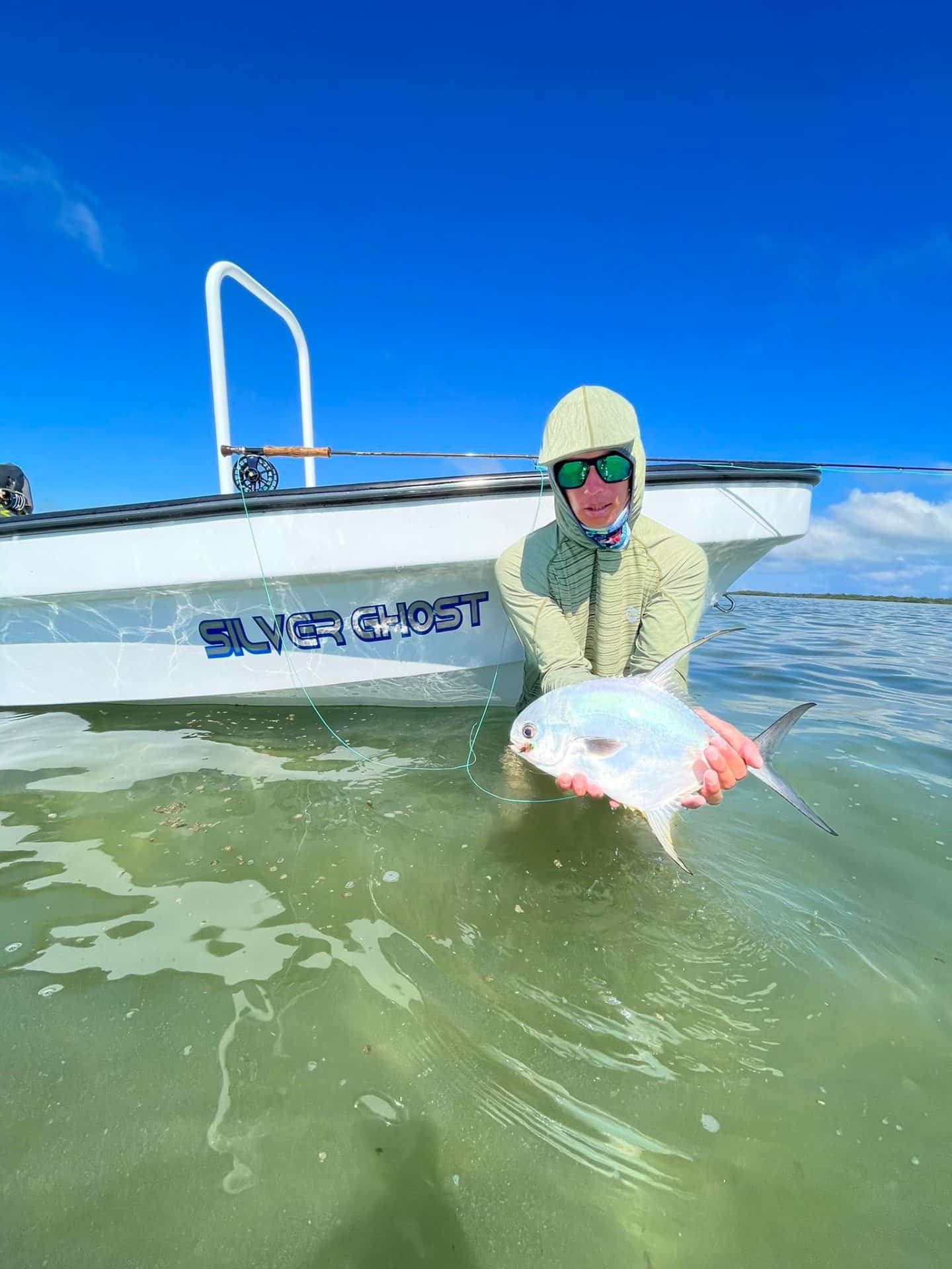 Fishing on the Silver Ghost boat, showcasing a catch under clear blue skies.