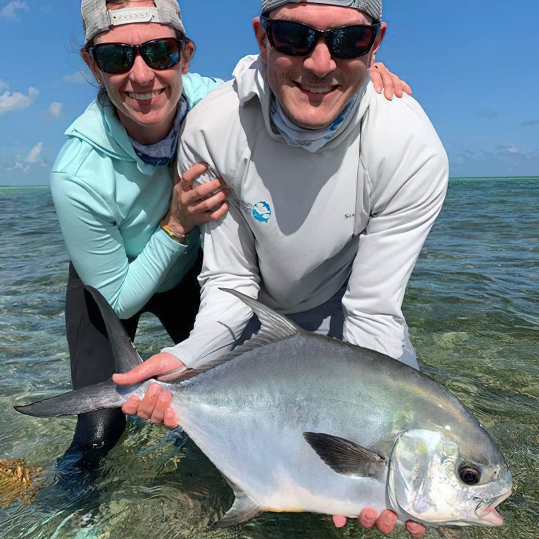 Joyful anglers proudly display their catch in a stunning fishing location.