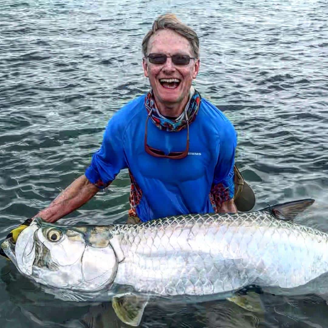 Angler joyfully showcases a massive fish catch from a successful fishing adventure.