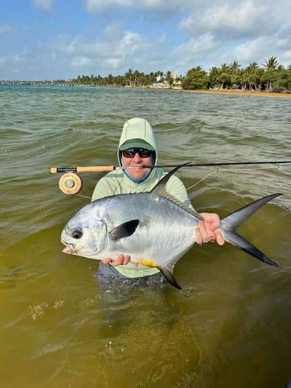Successful permit fishing adventure on the coast, showcasing a proud angler and catch.
