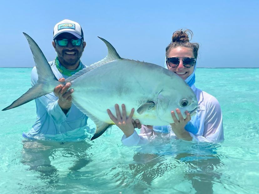 Happy anglers show off their large catch on a bright, sunny day.