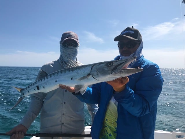 http://Men%20Holding%20Barracuda%20Fish