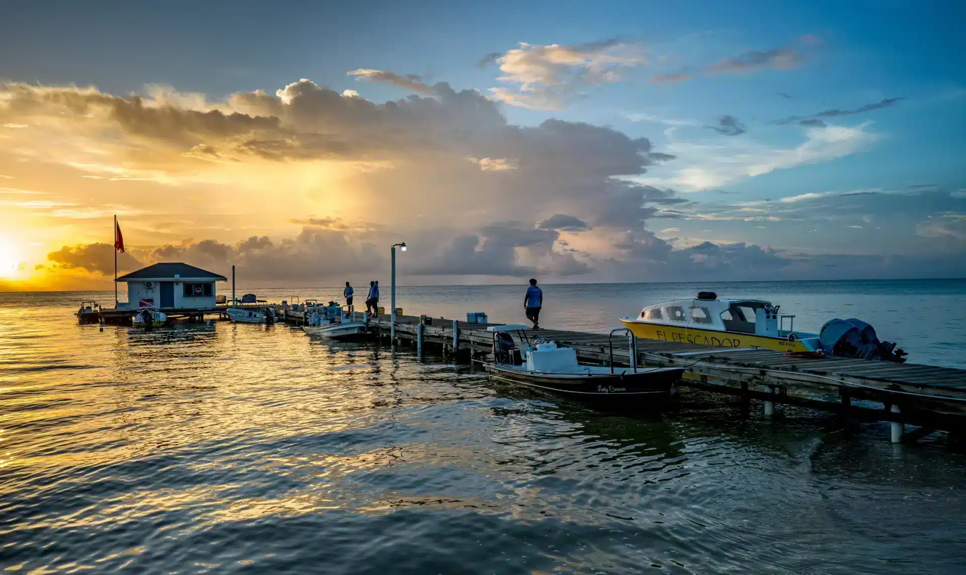 El Pescador dock with fishing boats at sunset