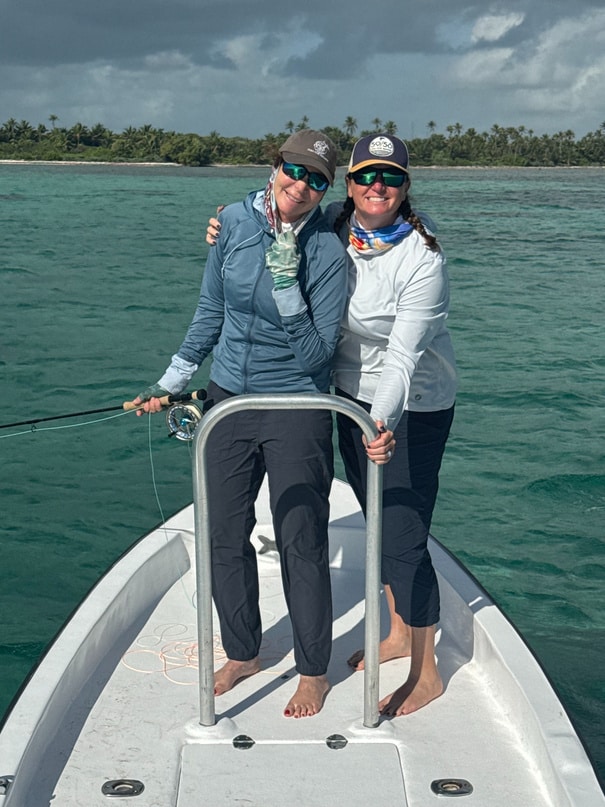 Whitney Gould and Megan Nellen together on the bow of a flats boat in Belize